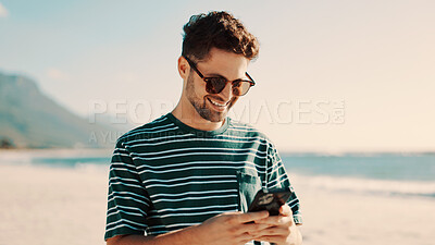 Buy stock photo Man, scroll and smile with phone at beach for social media joke, funny online meme and summer holiday. Happy person, typing and vacation with tech by ocean for mobile app, internet humor and space.