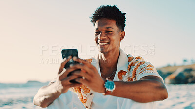 Buy stock photo Break, phone and smile with man on beach for holiday, travel or vacation review as tourist. App, relax and social media with happy person outdoor on coast for feedback on getaway or trip destination