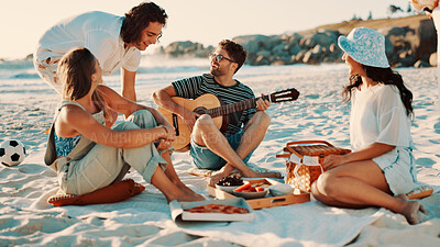 Buy stock photo Beach, friends and play guitar on picnic, relax and laugh together outdoor for holiday party. Seashore, food and people with acoustic instrument for music, social gathering or funny joke on vacation