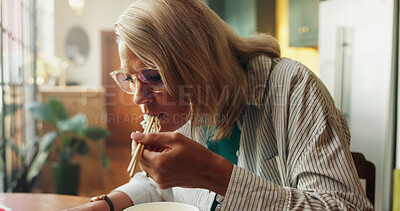 Buy stock photo Noodles, chopsticks and meal with woman in kitchen of home for break, diet or hunger. Eating, Chinese food and takeaway with person in apartment for lunch, nutrition or ramen snack for wellness