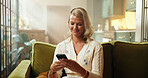 Break, phone and text message with woman on sofa in living room of home for social media browsing. App, relax and typing with happy person in apartment for email, mobile communication or research