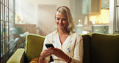 Buy stock photo Break, phone and text message with woman on sofa in living room of home for social media browsing. App, relax and typing with happy person in apartment for email, mobile communication or research