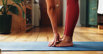 Yoga, woman and stretching in home with feet for health, wellness and fitness on mat. Yogi, hands and person exercise with legs in house for holistic flexibility, self care and pilates warm up