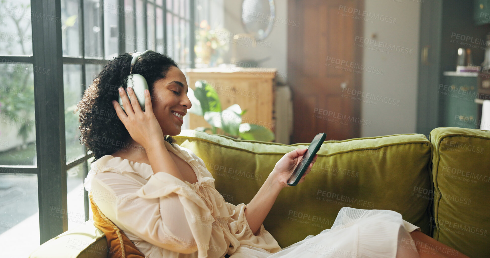 Buy stock photo Headphones, tablet and woman on sofa in home with listening to music, radio or song on app. Digital technology, relax and female person streaming playlist, podcast or album online in living room.