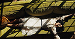 Relax, stretching and above of woman on sofa of home for calm, stress relief and weekend break. Comfortable, resting and chill with top view of person in living room of apartment for wellness and nap