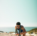 Fitness, break and man with smart watch by beach, mockup space and check heart rate for training. Running pause, track distance and athlete with tech to count steps, sunglasses and monitor rest time