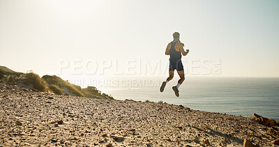 Buy stock photo Fitness, horizon and jump at ocean with man outdoor for adventure or energy from back. Celebration, exercise and sea view with excited hiker in nature for physical activity, milestone or trekking