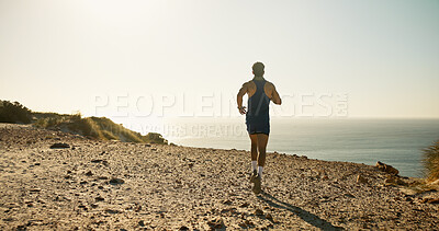 Buy stock photo Back, horizon and running at ocean with man on sand outdoor for adventure or fitness hobby. Coast, exercise or sea view and person training on cliff in nature for cardio or wellness with mockup space