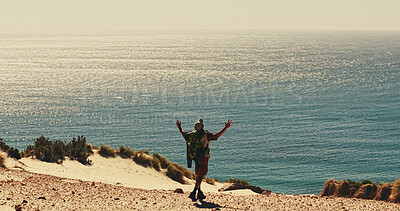 Buy stock photo Celebration, hiking and horizon at ocean with man on sand outdoor for fitness or hobby from back. Exercise, milestone and sea space with hiker in nature for physical activity, trekking or wellness