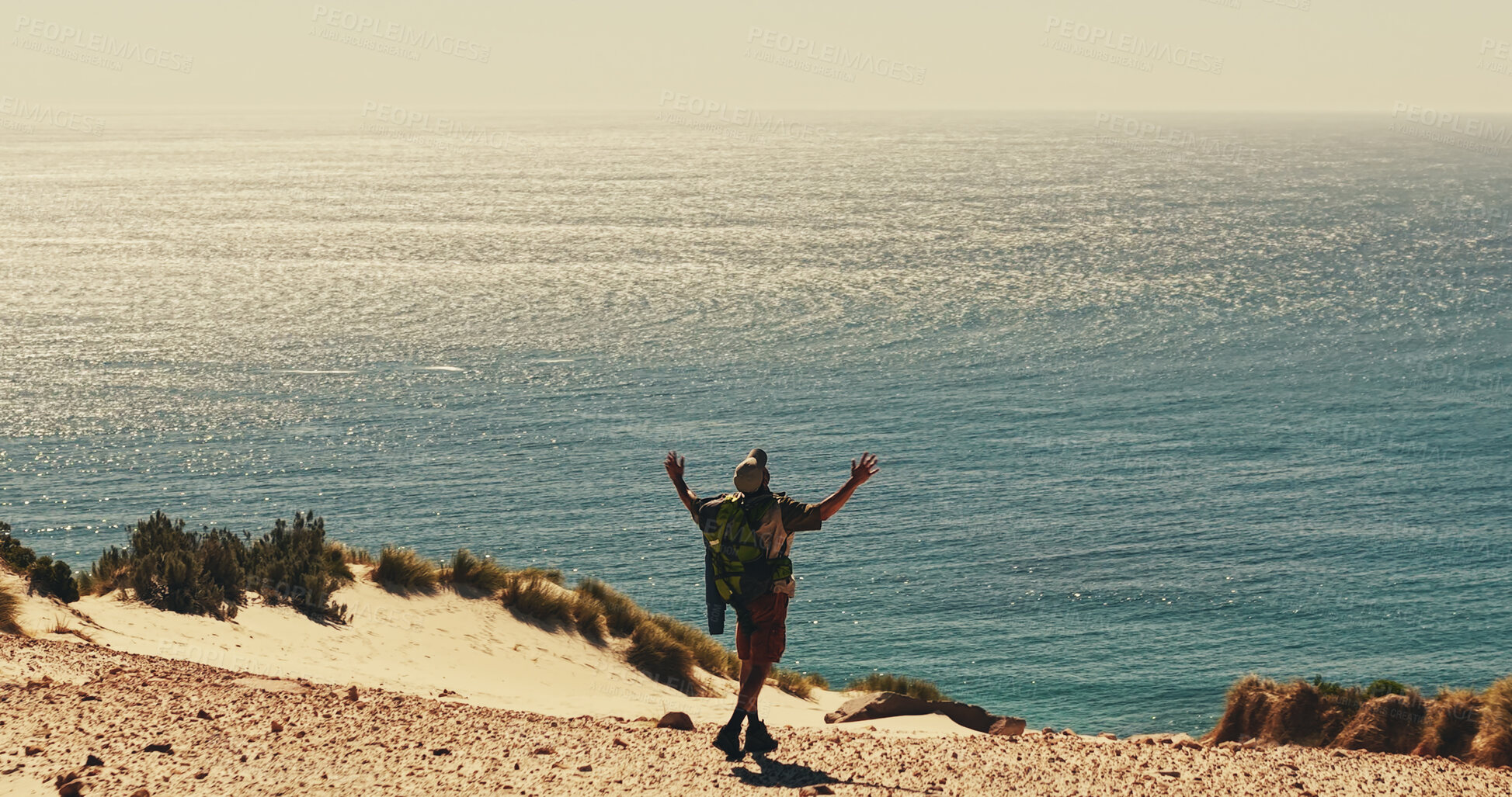 Buy stock photo Celebration, hiking and horizon at ocean with man on sand outdoor for fitness or hobby from back. Exercise, milestone and sea space with hiker in nature for physical activity, trekking or wellness