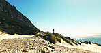 Horizon, hiking and man with view for travel, adventure or fitness for journey with backpack. Male person, trekking and explore dune for exercise, eco tourism and nature space for holiday or vacation