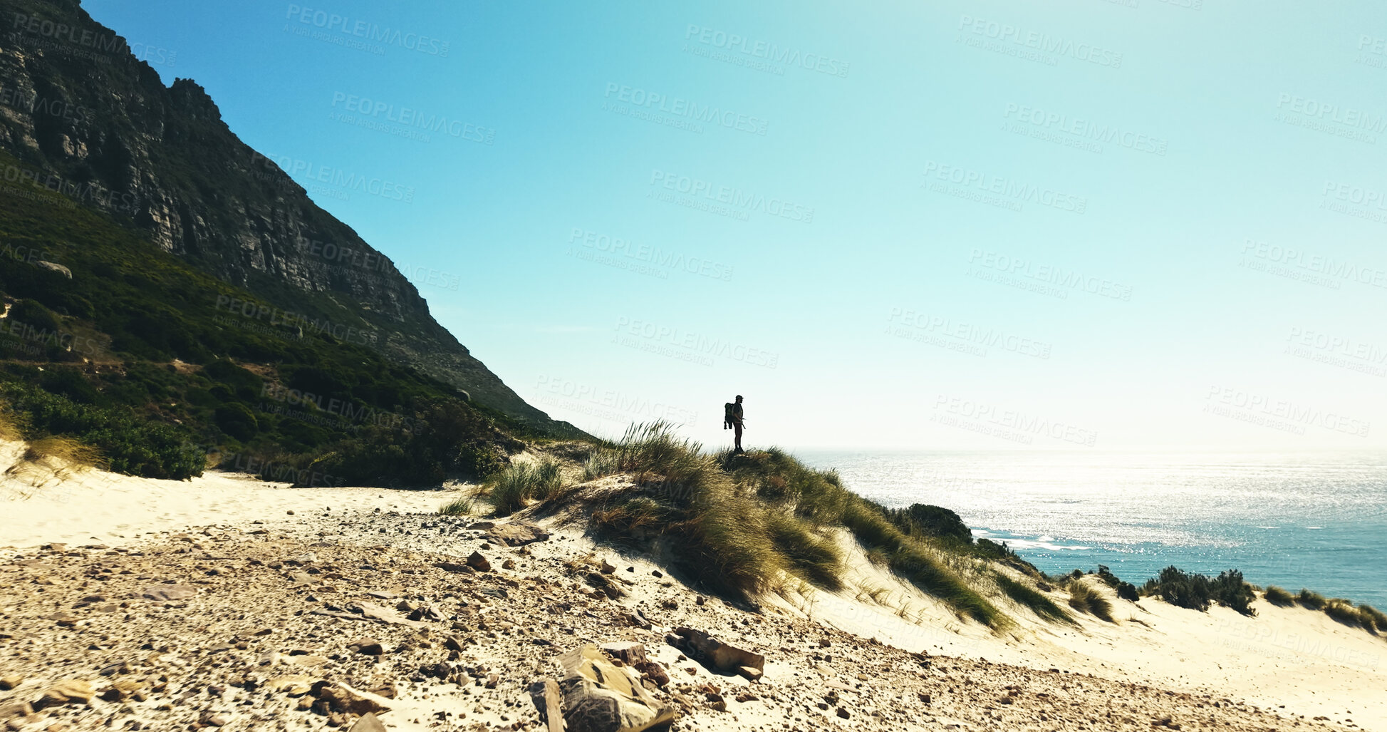 Buy stock photo Horizon, hiking and man with view for travel, adventure or fitness for journey with backpack. Male person, trekking and explore dune for exercise, eco tourism and nature space for holiday or vacation