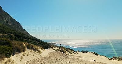 Buy stock photo Mockup, hiking and man with space for travel, adventure and fitness for journey with backpacking. Person, trekking and flare on dune for exercise, eco tourism and nature view for holiday or vacation