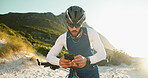Fitness, cyclist and man with phone in nature for networking, chatting or connectivity with training. Sports, cycling and athlete with cellphone for texting, communication or contact on mobile app.