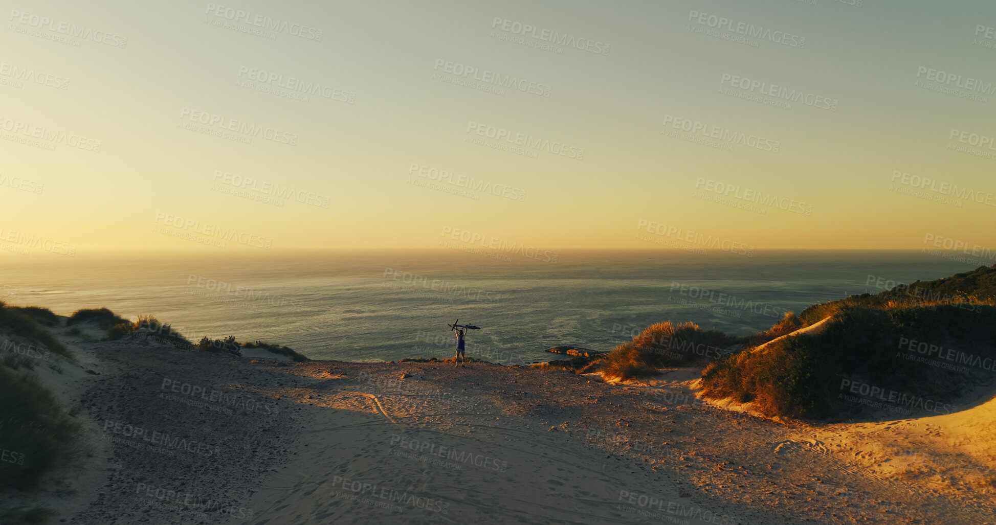 Buy stock photo Aerial view, bicycle and man with celebration for sunset, travel or fitness for journey and achievement. Person, cycling and horizon for exercise, eco tourism and nature space for holiday or vacation