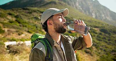 Buy stock photo Mountain, drinking water and man with break for hiking, hydration or summer tourism for travel trip. Outdoor, wellness and person relax with liquid bottle, trekking or thirsty on sightseeing vacation