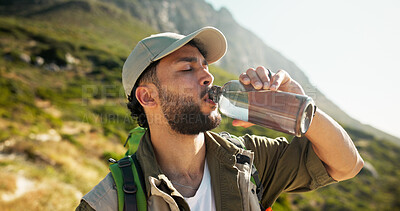Buy stock photo Mountain, relax and man drinking water for hiking hydration, summer traveling or eco tourism on nature trip. Outdoor, wellness and person with liquid bottle for break, trekking or thirsty on vacation