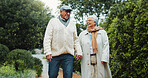 Holding hands, walking and senior couple in nature with bonding together on holiday, getaway or adventure. Happy, support and elderly man with woman outdoor for connection, love or marriage in park.