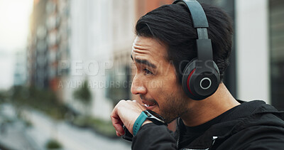 Buy stock photo Thinking, athlete and man with headphones outdoor for fitness, streaming podcast and exercise. Thoughts, male person and smart watch for training, listening to music and reflection for wellness goals