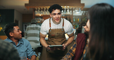 Buy stock photo Waiter man, tablet and group at bar for order, talk and option for drinks, choice and wine list. People, friends and server with tech, digital menu app or customer experience with decision at pub
