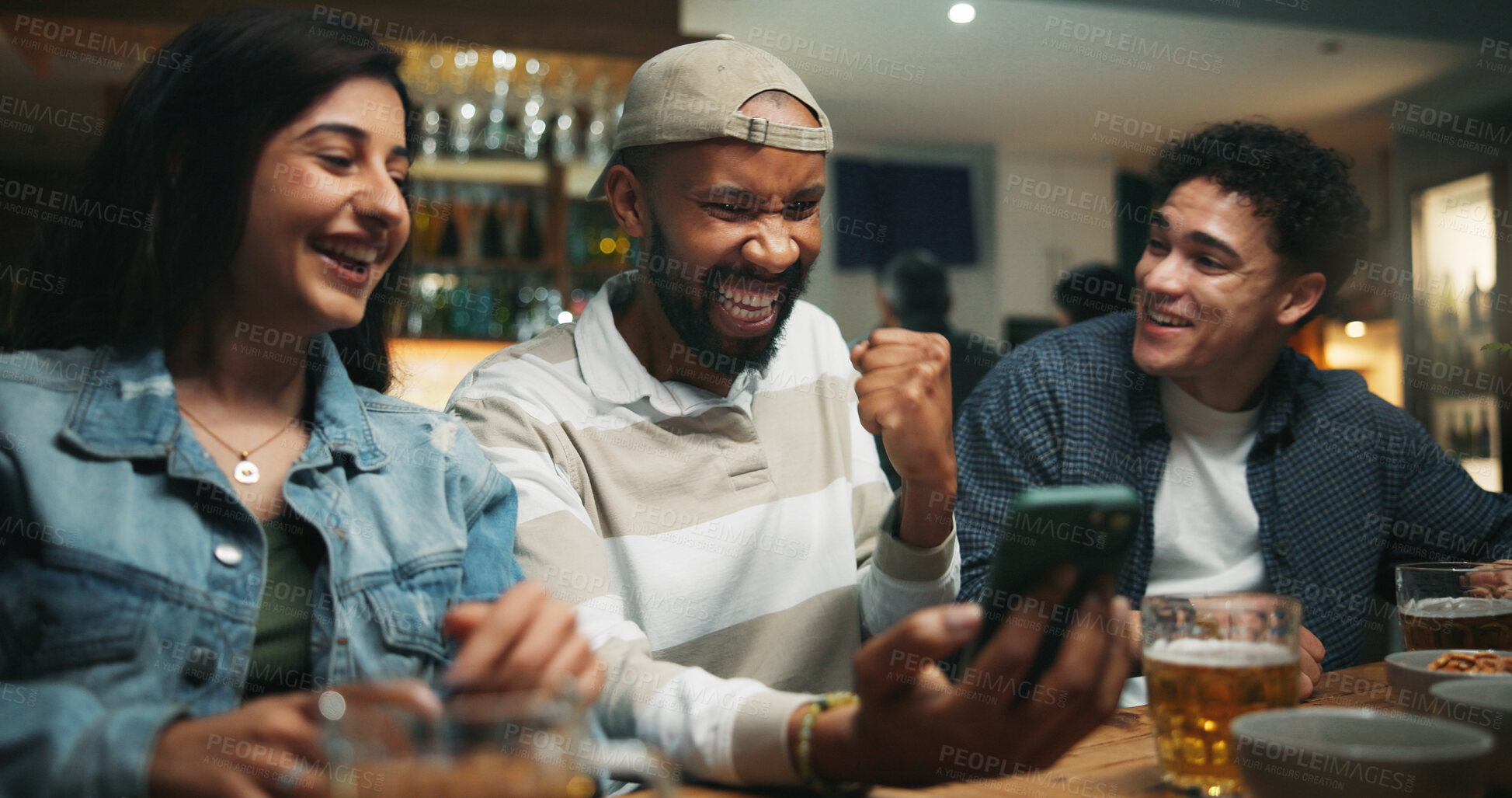 Buy stock photo Winning, friends and fist pump with phone in pub for streaming match, sports goal and team support. Football fans, people or smartphone with celebration in bar for game score, live broadcast or event