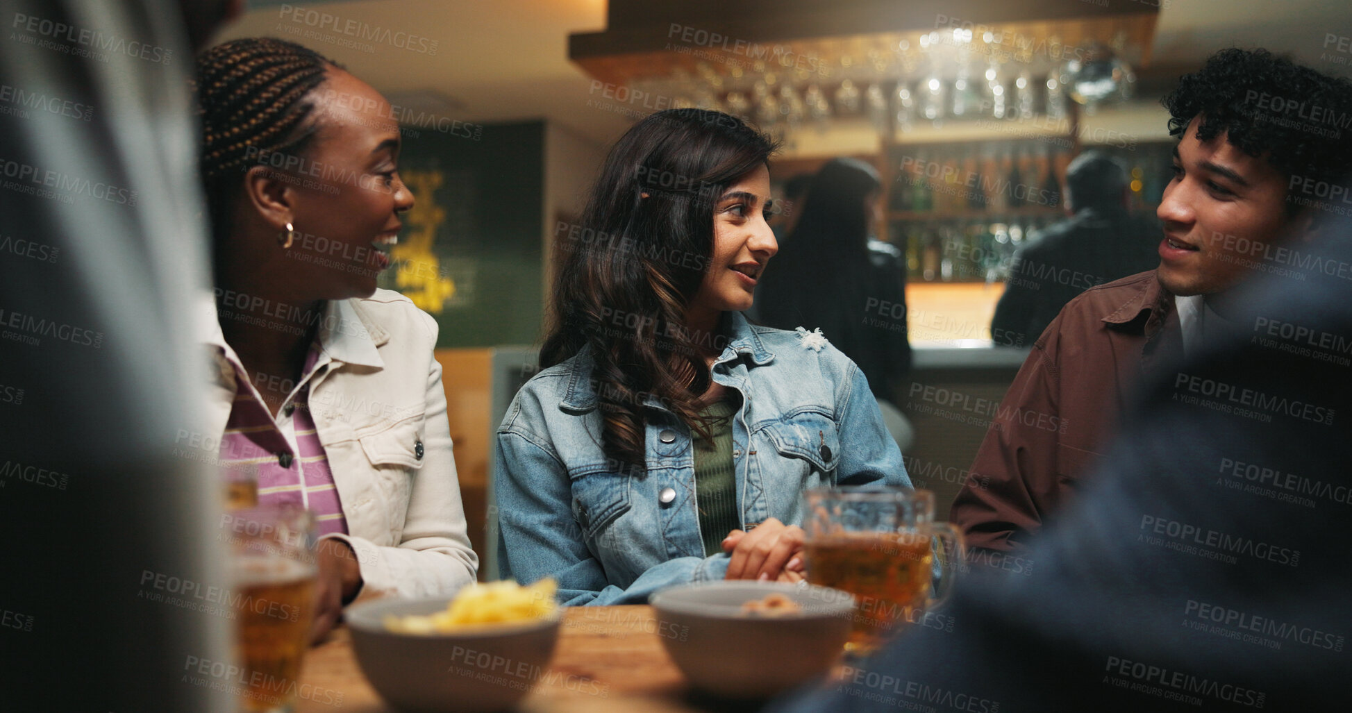 Buy stock photo Conversation, friends and people in pub, alcohol and bonding together with reunion. Group, men and woman in restaurant, discussion and celebration with beer, humor and social gathering with happiness