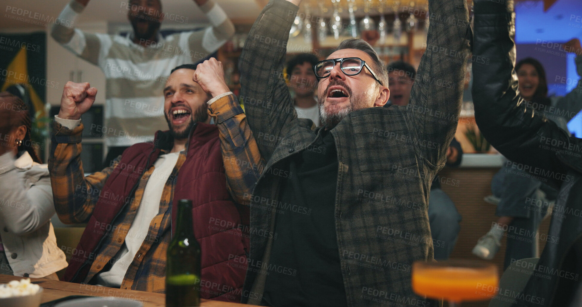 Buy stock photo Man, friends and celebration at sports bar, watching tv or fist pump for goal in soccer competition. People, group and excited for cheers, football match or live stream for international game at pub
