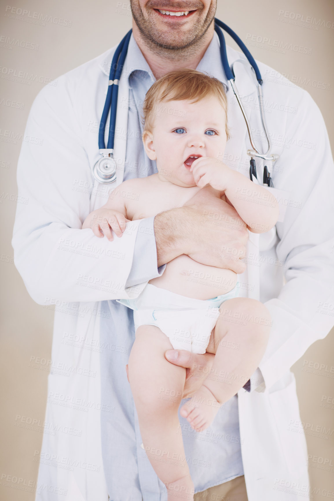 Buy stock photo Healthcare, carry and doctor with baby in studio for medical service, wellness and pediatrician career. Pediatrics, background and man with child for medicare, help and consultant for family clinic
