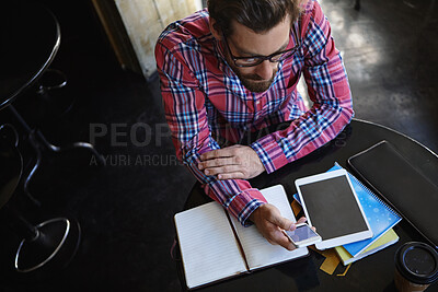 Buy stock photo Man, smartphone and texting at cafe for remote work, above and blank screen with mockup space at diner. Person, freelance writer and glasses with tablet, phone or notebook for project at coffee shop