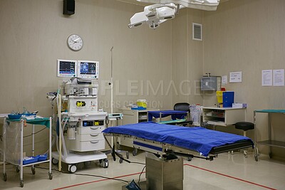 Buy stock photo Operating room, empty and hospital bed with healthcare, equipment or compliance policy. Theater, medical emergency or healing facility with treatment, procedure or machine with wellness or innovation