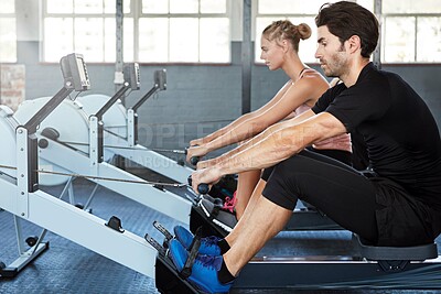 Buy stock photo Fitness, man and rowing machine at gym for strength training, endurance workout or cardio challenge. People, athlete and ergometer at health club for resistance exercise, posture and muscle growth