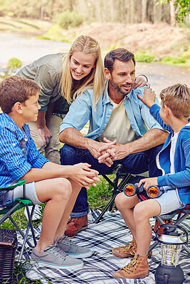 Buy stock photo Camping, family and kids with picnic, conversation and vacation in countryside. Parents, children and forest for weekend break, trip or holiday for summer travel at campsite together in woods