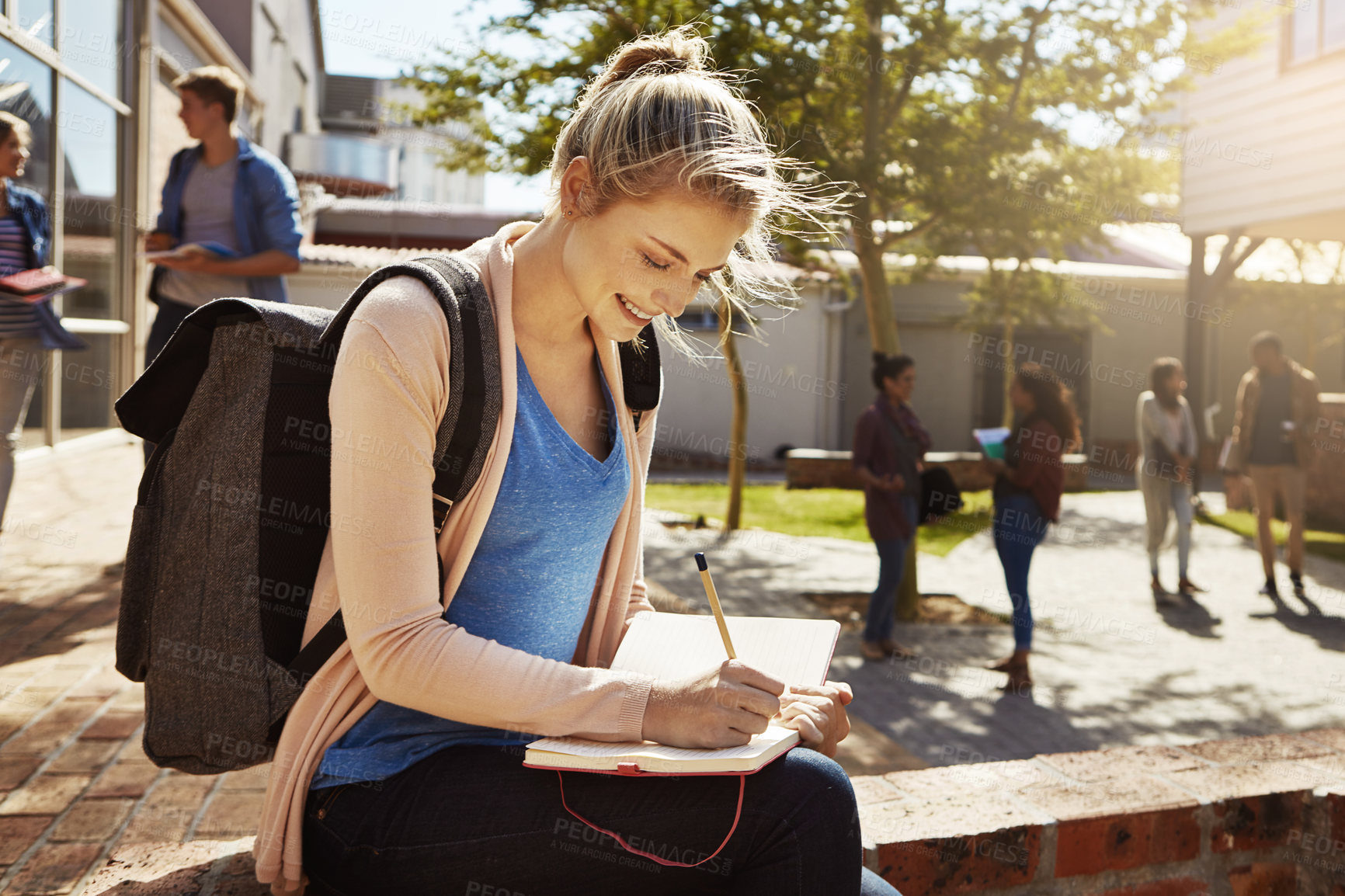 Buy stock photo College student, girl and writing in notebook on campus for lecture notes, study tips and journaling. Happy, person and diary outdoor at university for assignment planner, essay planning or education