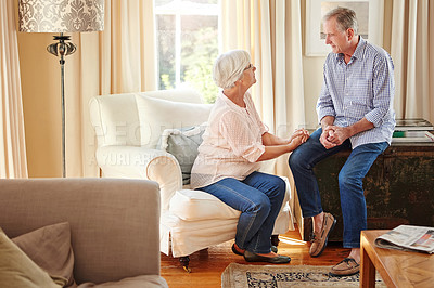 Buy stock photo Elderly couple, love and talking in home for bonding, relax and encouragement on sofa. Senior man, woman and discussion in living room for retirement planning, conversation and mental health support