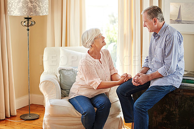 Buy stock photo Senior couple, love and talking in home for bonding, relax and encouragement on sofa. Elderly man, woman and discussion in living room for retirement planning, conversation and mental health support
