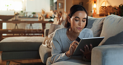 Buy stock photo Credit card, relax and tablet with woman on sofa in living room of home for online shopping at night. App, bank and ecommerce with confident person in apartment for financial transaction on weekend