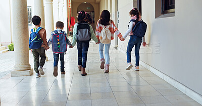 Buy stock photo Kids, holding hands and group with back at school with care, connection and support in hallway. Children, friends and together with bonding, education and development with scholarship at academy
