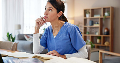 Buy stock photo Nurse, woman and thinking with books at desk for medical research, information and knowledge. Healthcare, worker and planning with idea at home for diagnosis solution, reference and treatment review