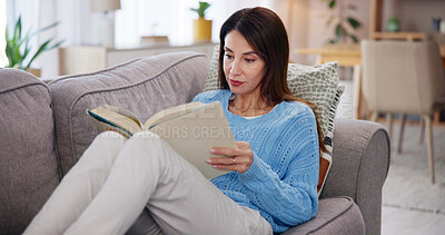 Buy stock photo Woman, reading and book on sofa in home for story, fiction tale and literature hobby to relax. Person, fantasy novel or learning information on couch in lounge for education, knowledge or comfortable