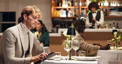 Buy stock photo Frustrated, waiting and man with phone in restaurant for late date, annoyed and schedule. Text message, cancel appointment and worry with person at dinner for time, hospitality and reservation