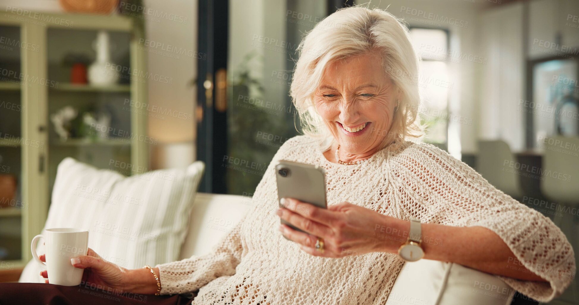 Buy stock photo Home, smartphone and old woman on sofa, smile and funny meme with social media. Apartment, mobile user and mature person on couch, cellphone and message to contact, texting and app for online humor