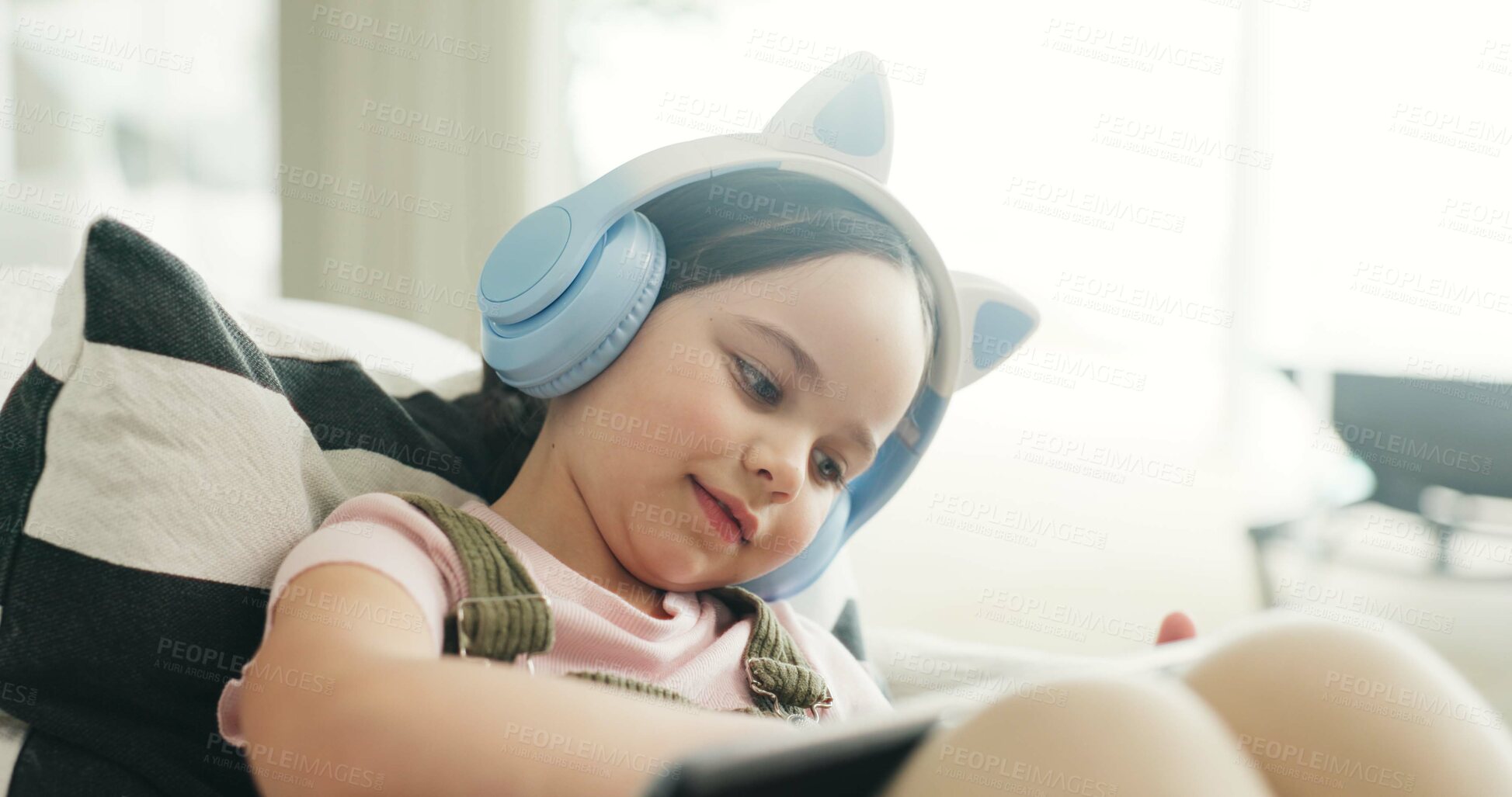 Buy stock photo Headphones, kid or elearning with tablet on sofa, watch lesson or school website for education. Flare, class live stream or girl with digital app for teaching video, home or listen with audio tech