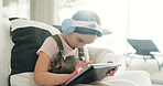 Headphones, child or elearning with tablet on couch, watch lesson or education website for concentration. Flare, class live stream or girl with app for teaching video, home or listen with audio tech