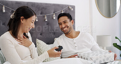 Buy stock photo Christmas, love or couple in bed with gift, romantic moment or gratitude in xmas morning. Festive, happiness or people in house with present, healthy relationship or appreciation in holiday tradition