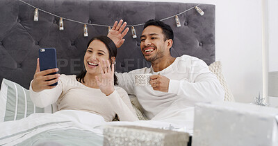 Buy stock photo Video call, couple and celebration in bed with Christmas, communication and wave for festive season. Home, man and woman with present in bedroom for conversation, smile and social media on holiday