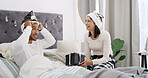 Laugh, couple and celebration in bed with Christmas, present and festive season for love in home. House, man and woman with gift in bedroom for Santa hat, smile and decoration for holiday bonding