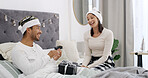 Christmas, love or couple in bed with gift box, romantic moment or gratitude in xmas morning. Festive, man and woman in house with present, healthy relationship or appreciation in holiday tradition