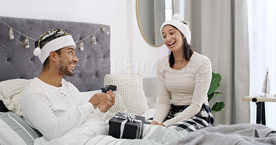 Buy stock photo Christmas, love or couple in bed with gift box, romantic moment or gratitude on xmas morning. Festive, man and woman in house with present, healthy relationship or appreciation in holiday tradition