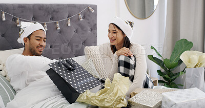 Buy stock photo Smile, couple and presents in bed with Christmas, giving and festive season for love in home. House, man and woman with celebration in bedroom for Santa hat, gift and decoration for holiday bonding