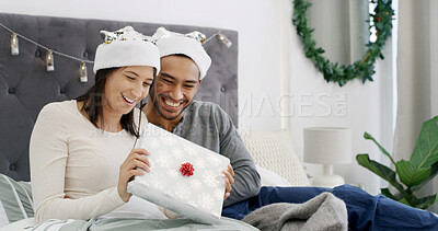 Buy stock photo Christmas, love or couple in house with gift, romantic moment or gratitude in xmas morning. Festive, happy or people in bedroom with present, healthy relationship or appreciation in holiday tradition